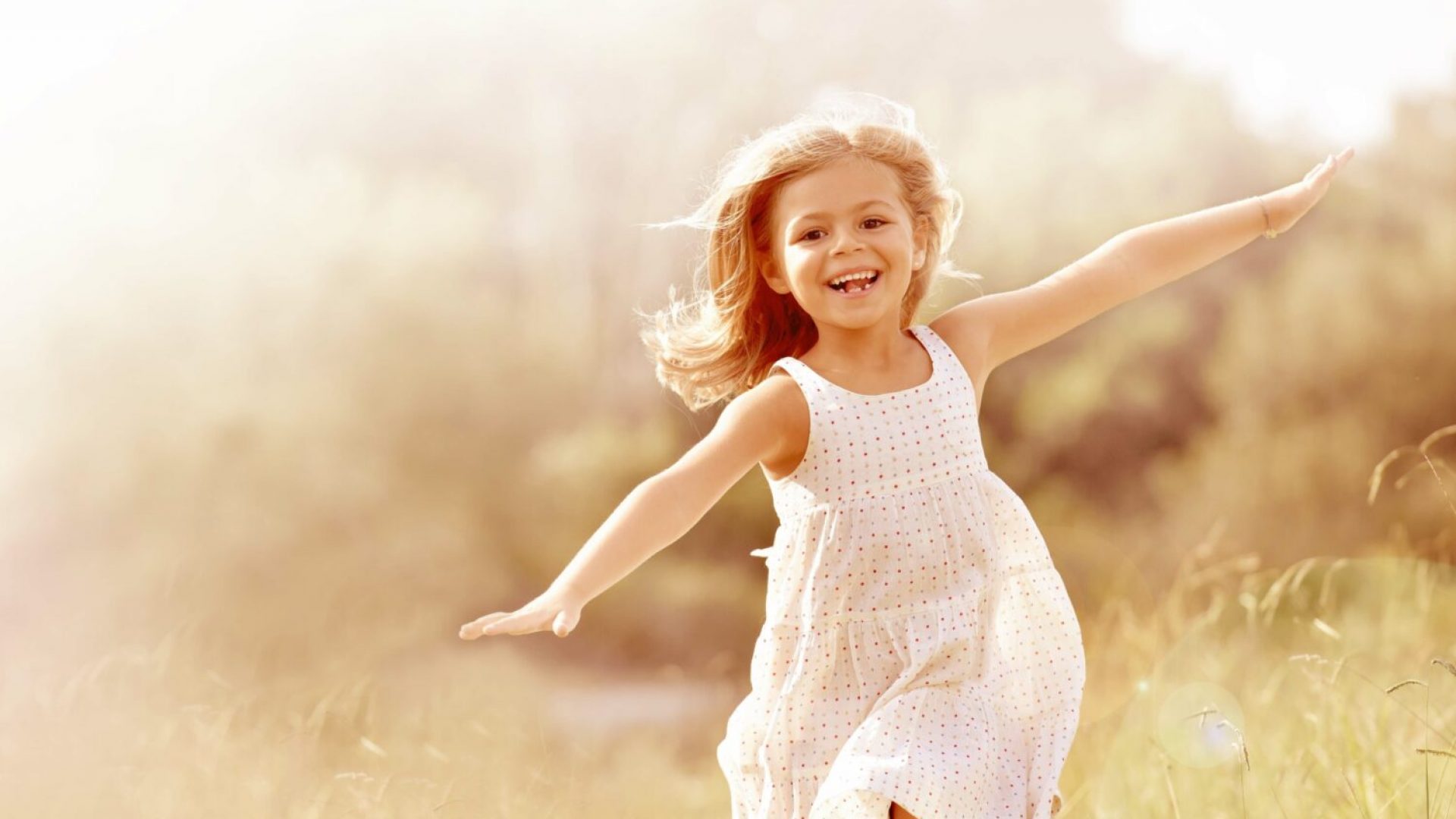 Little girl running in country field in summer Little girl running in country field in summer